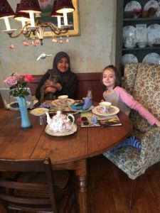 Andi and her host sister enjoy tea time together with the family cat
