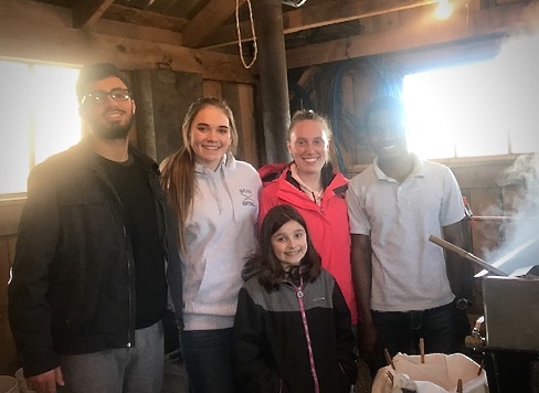 Abdul and Host Family Smile During Maple Syrup Making Excursion | Academic Year in America (AYA)