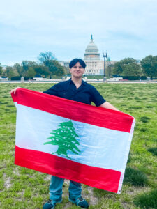 aya high school exchange student holding flag of lebanon in front of the U.S. Capitol building in Washington, DC