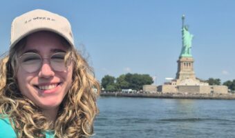 aya exchange student from germany at the statue of liberty in new york city, usa