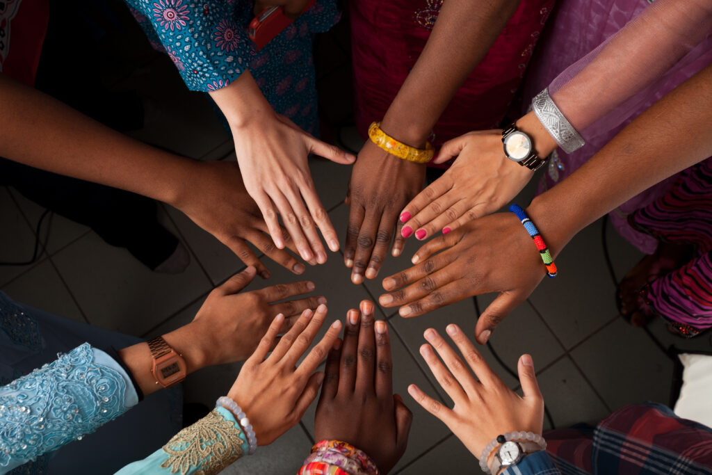 Hands of group of people which stay together in circle