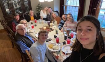 host family and exchange student eating dinner together