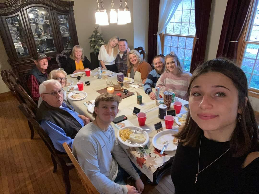 host family and exchange student eating dinner together